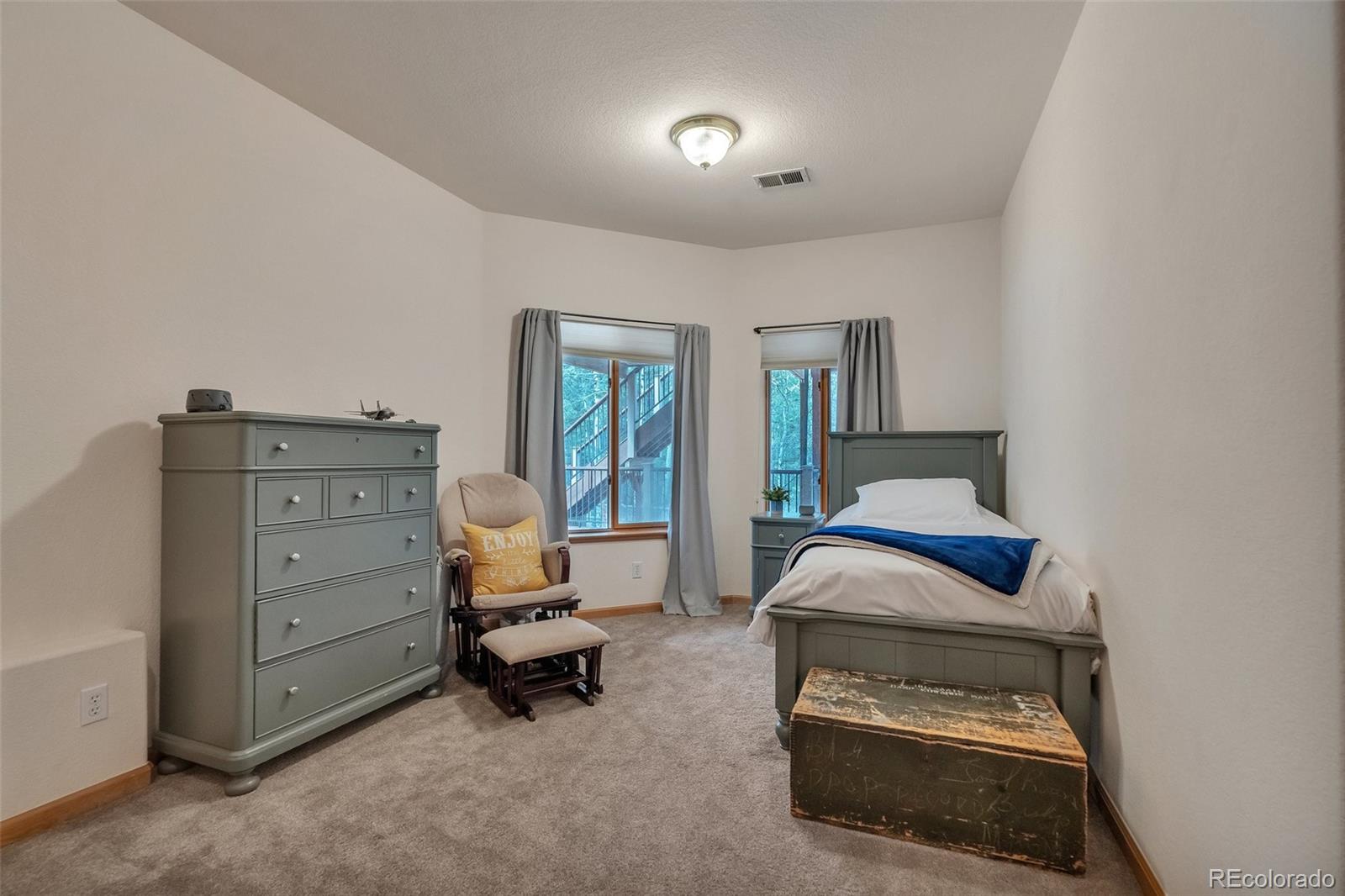 9590 South Warhawk Road Conifer, CO 80433 - Photo 27 of 43 a bedroom with a bed and furniture