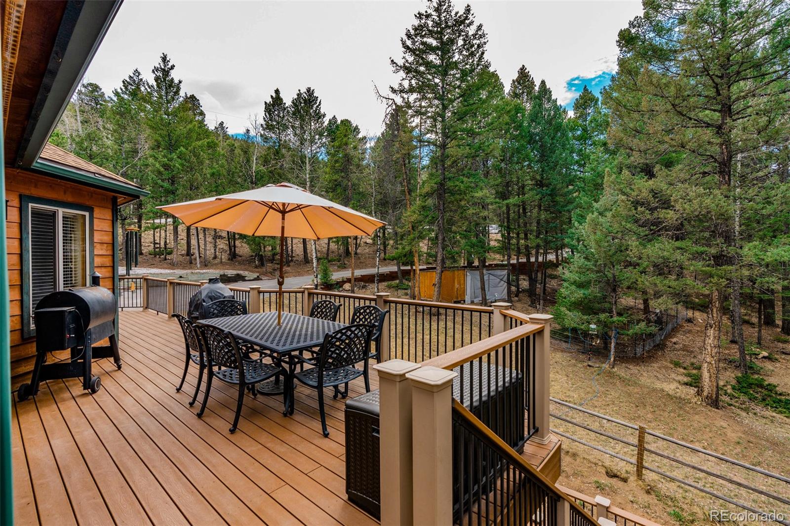 9590 South Warhawk Road Conifer, CO 80433 - Photo 35 of 43 a view of balcony with outdoor seating and wooden floor
