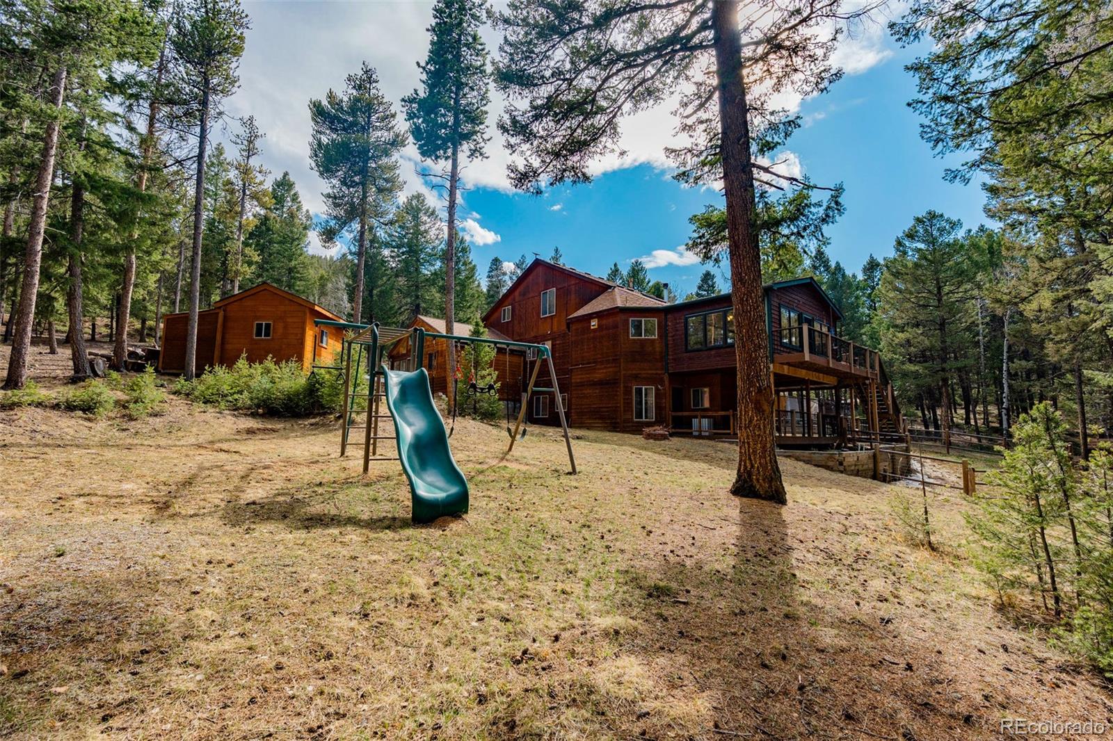 9590 South Warhawk Road Conifer, CO 80433 - Photo 36 of 43 a view of a park with a slide