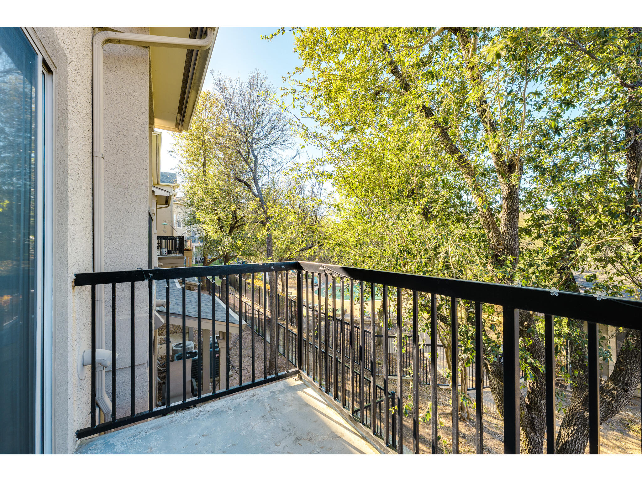 11203 Ranch Road 2222, Unit 106 Austin, TX 78732 - Photo 24 of 40 View of balcony towards the clubhouse and the pool