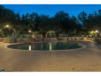 a view of a fountain is middle in the middle of a yard