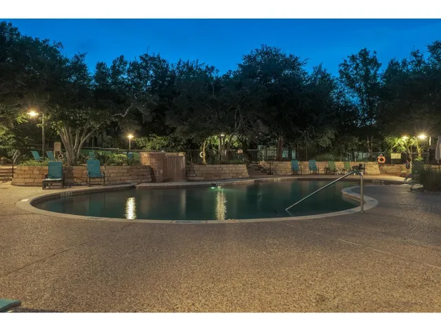 a view of a fountain is middle in the middle of a yard
