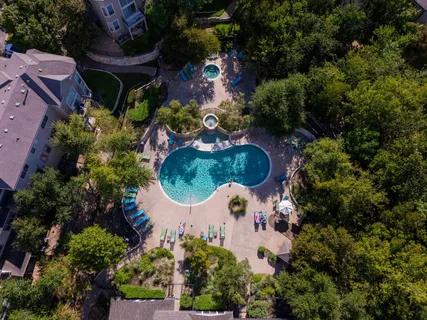 an aerial view of a house with a swimming pool a yard and outdoor seating