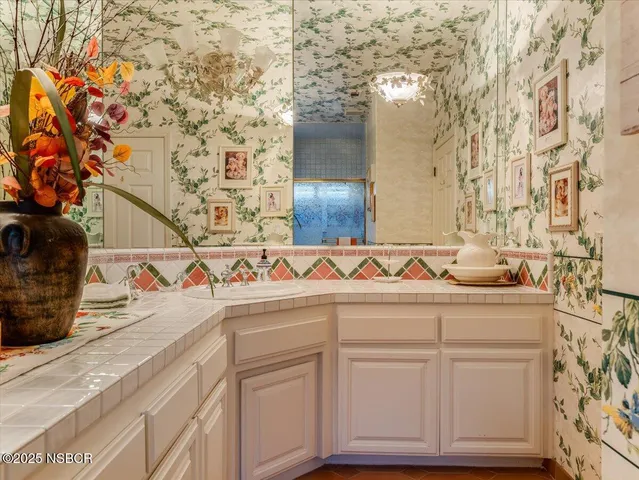 a bathroom with a sink and mirror