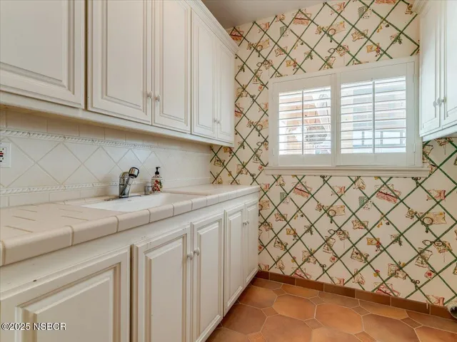 a kitchen with a sink and cabinets