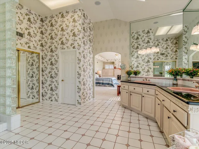 a large white kitchen with a sink and cabinets