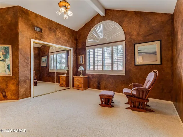 a living room with furniture and a pool table