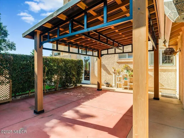 a backyard of a house with a fountain and a porch