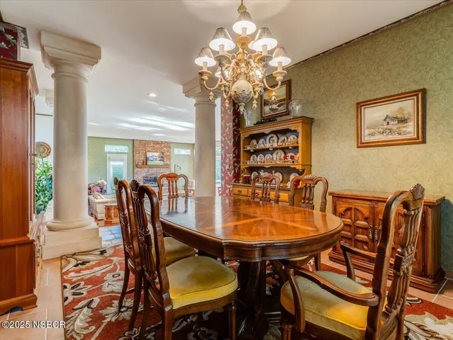 a view of a dining room with furniture and chandelier