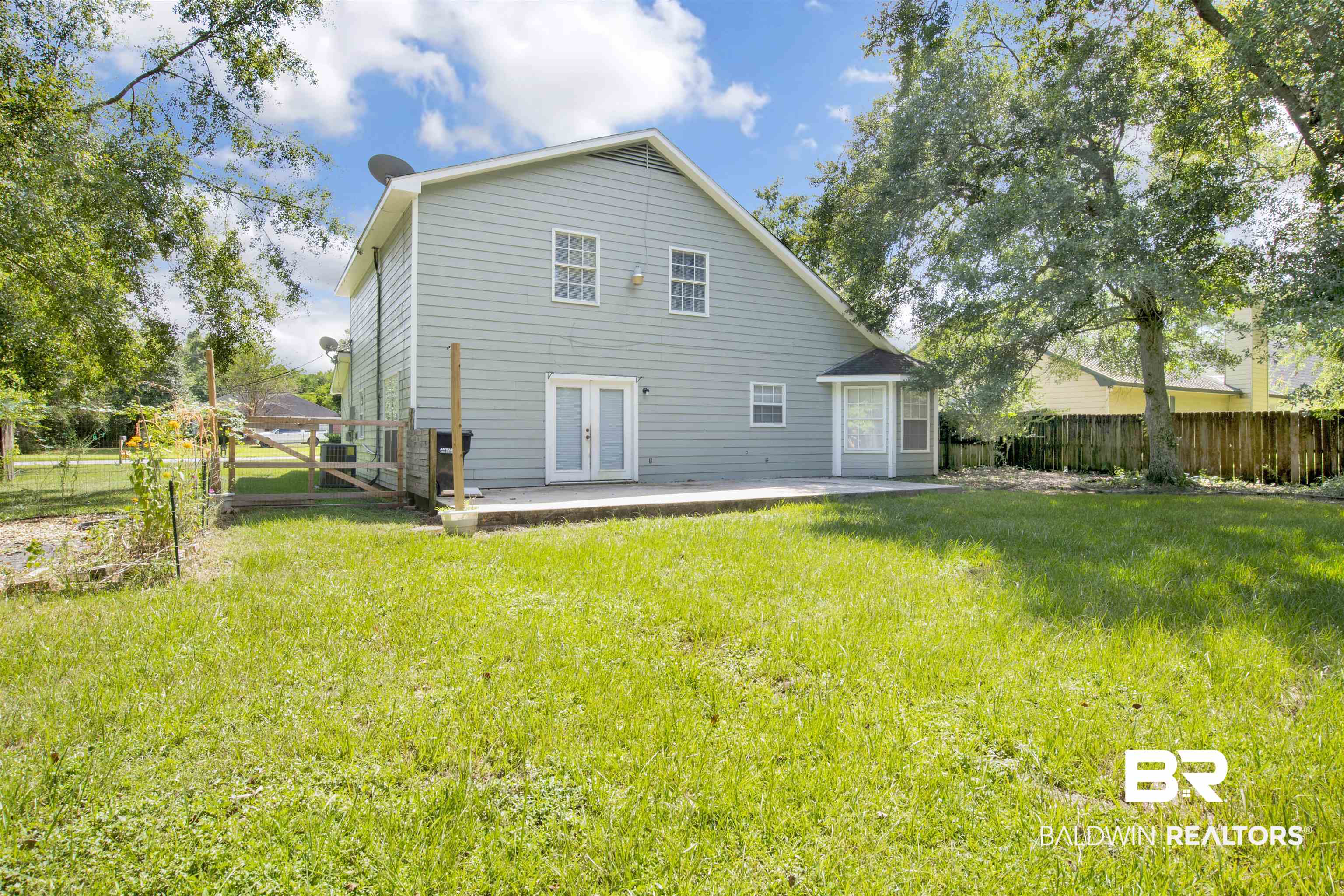 5480 Country Club Boulevard Theodore, AL 36582 - Photo 34 of 36 Rear view of property with french doors, a patio area, and a lawn