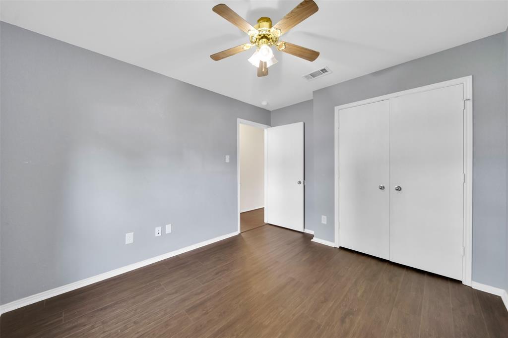 4221 Fiste Denton, TX 76207 - Photo 18 of 26 Unfurnished bedroom featuring dark hardwood / wood-style flooring, ceiling fan, and a closet