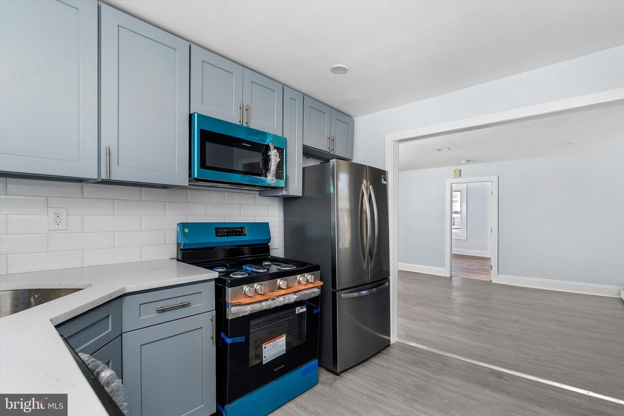10 Lytle Street, Unit 3 Princeton, NJ 08542 - Photo 11 of 17 a kitchen with stainless steel appliances a stove a microwave and a hard wood floors