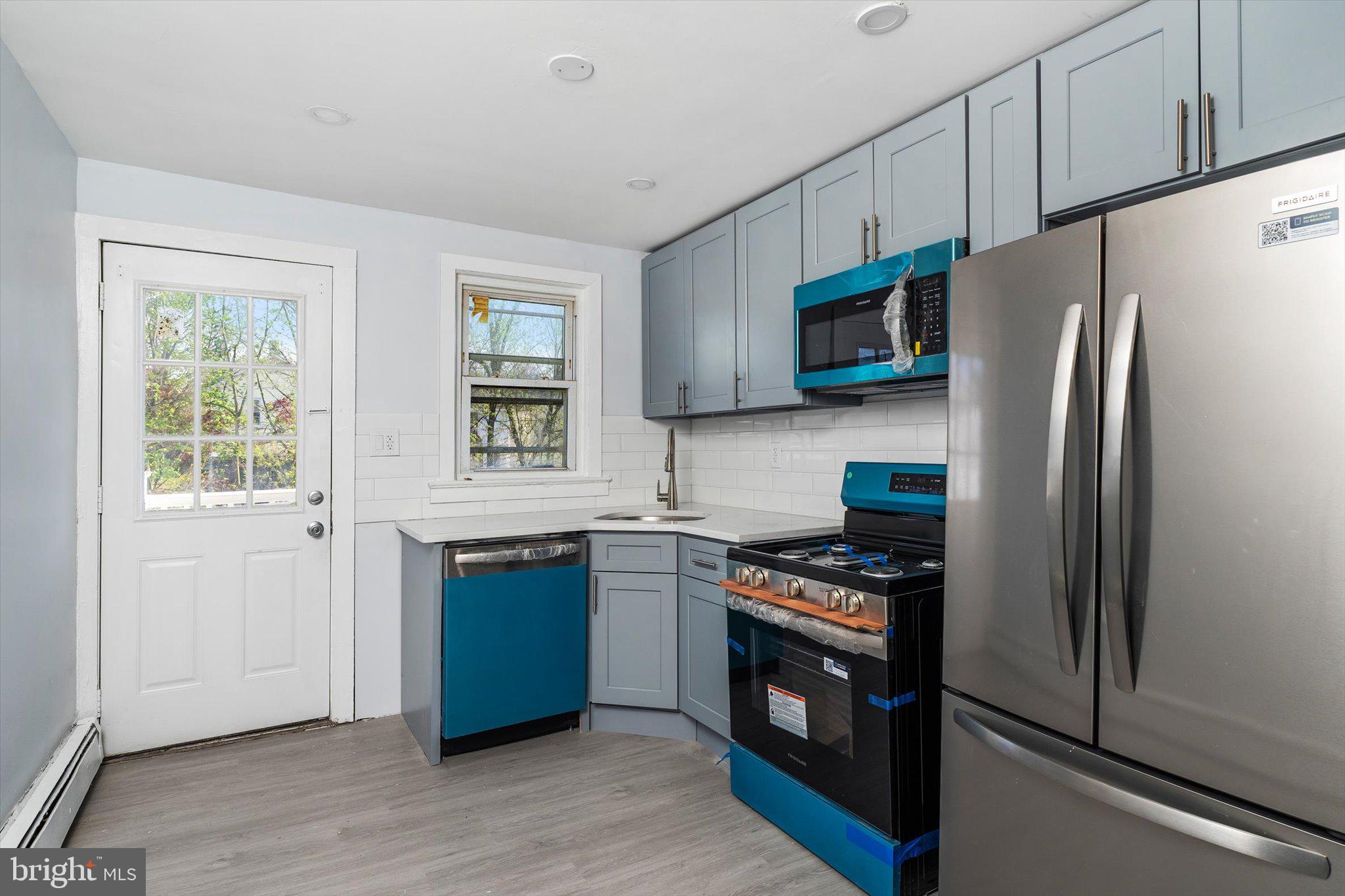 10 Lytle Street, Unit 3 Princeton, NJ 08542 - Photo 10 of 17 a kitchen with stainless steel appliances granite countertop a refrigerator stove and sink