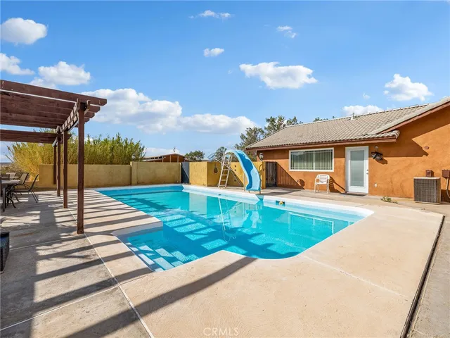 a view of a dining room with furniture large windows and wooden floor