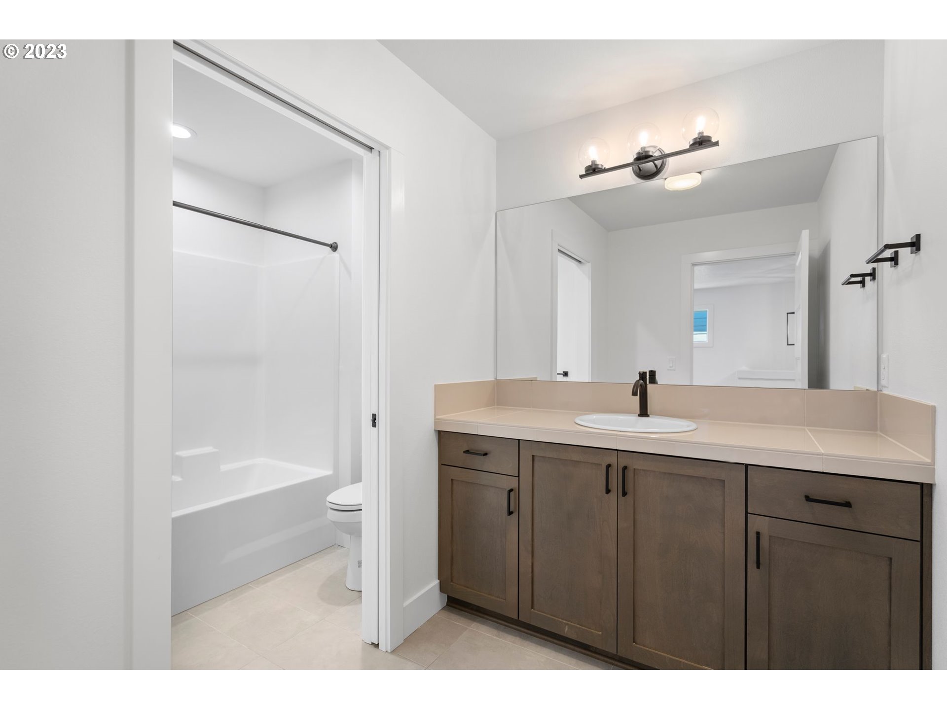 715 Northwest 175th Way Ridgefield, WA 98642 - Photo 16 of 26 a bathroom with a sink a large mirror and shower