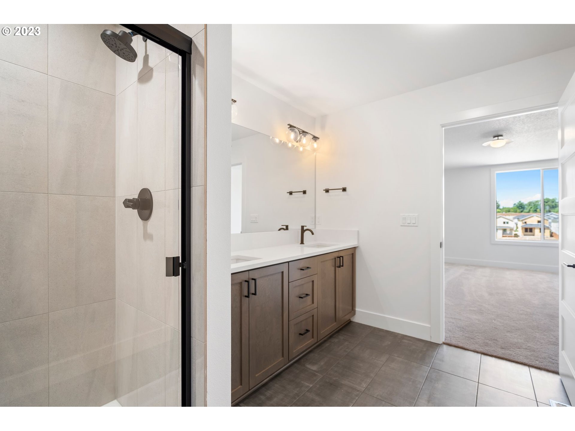 715 Northwest 175th Way Ridgefield, WA 98642 - Photo 25 of 26 a bathroom with a double vanity sink a mirror and a shower