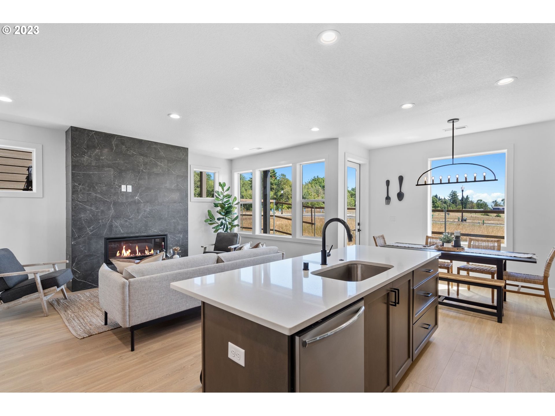 715 Northwest 175th Way Ridgefield, WA 98642 - Photo 3 of 26 a kitchen with a sink a counter top space and living room view