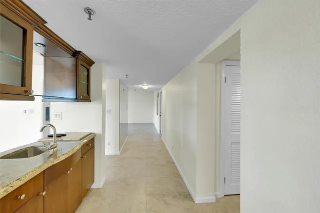 an empty room with windows and ceiling fan