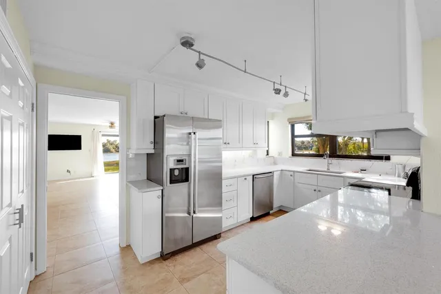 a kitchen with appliances a sink and cabinets