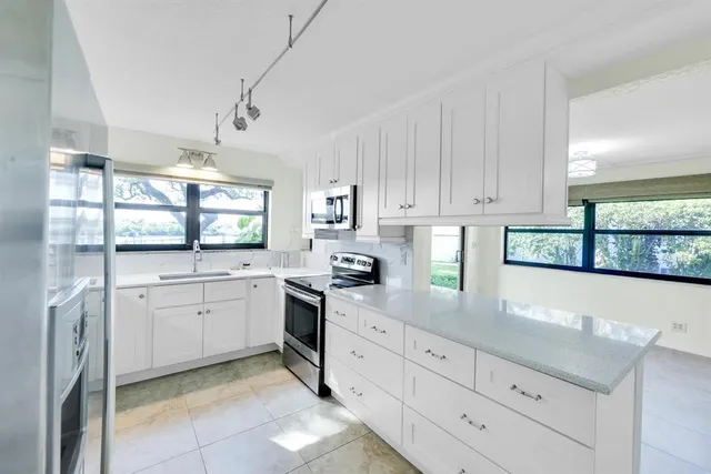 a view of an empty room with a cabinet and mirror