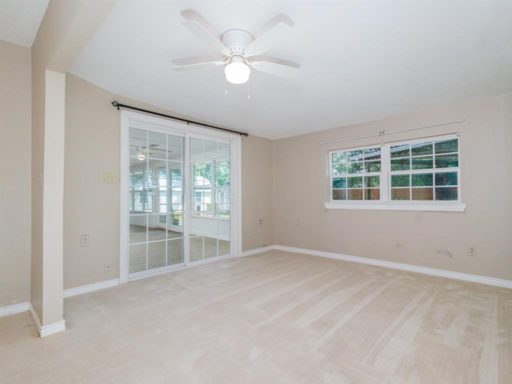 4002 Austin Avenue Brownwood, TX 76801 - Photo 24 of 34 an empty room with windows and ceiling fan