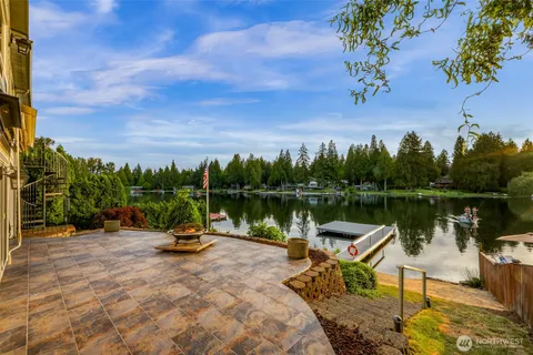 a lake view with a wooden fence and a bench