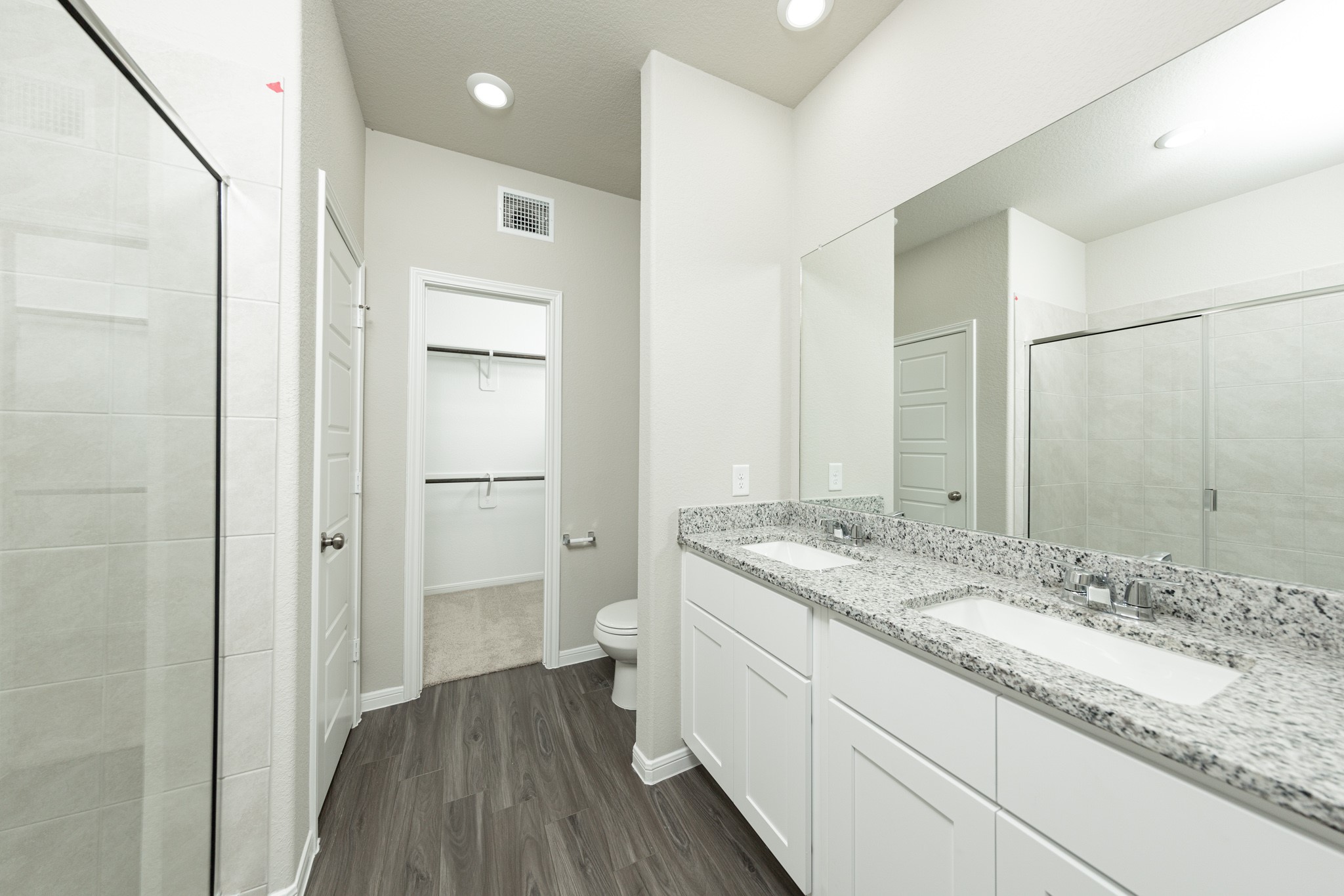 3878 Avalon Lane Conroe, TX 77301 - Photo 11 of 28 a bathroom with a granite countertop sink toilet and shower