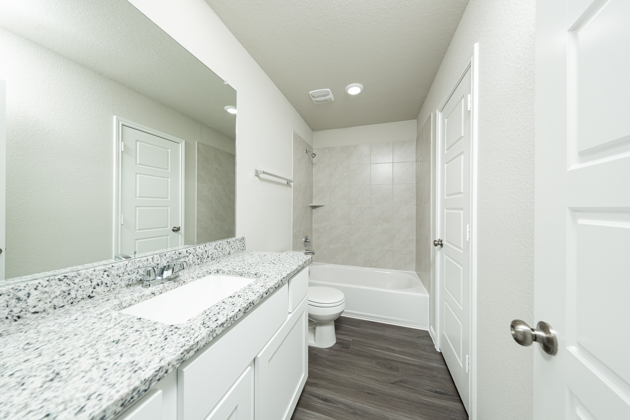 3878 Avalon Lane Conroe, TX 77301 - Photo 16 of 28 a bathroom with a granite countertop sink a toilet and shower
