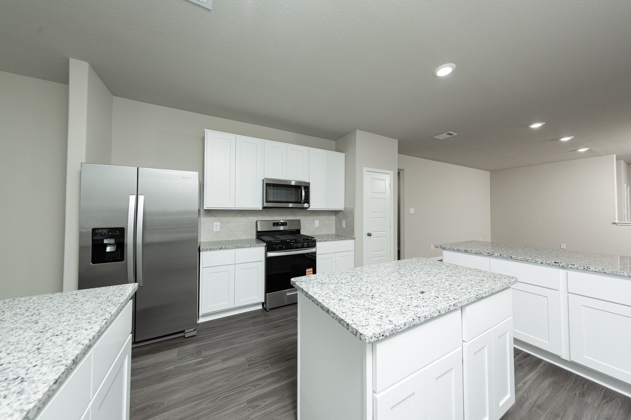 3878 Avalon Lane Conroe, TX 77301 - Photo 2 of 28 a kitchen with a center island and stainless steel appliances