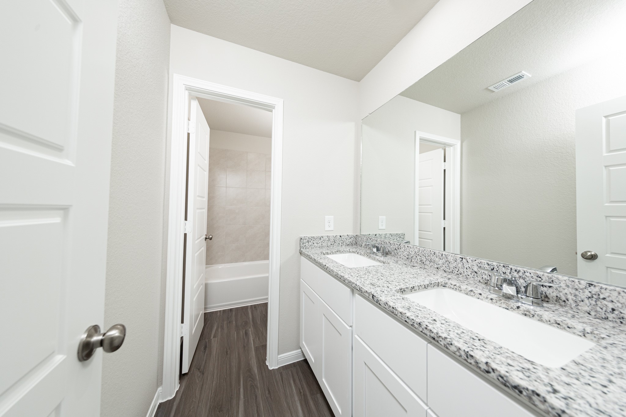 3878 Avalon Lane Conroe, TX 77301 - Photo 21 of 28 a bathroom with a granite countertop double vanity sink and mirror
