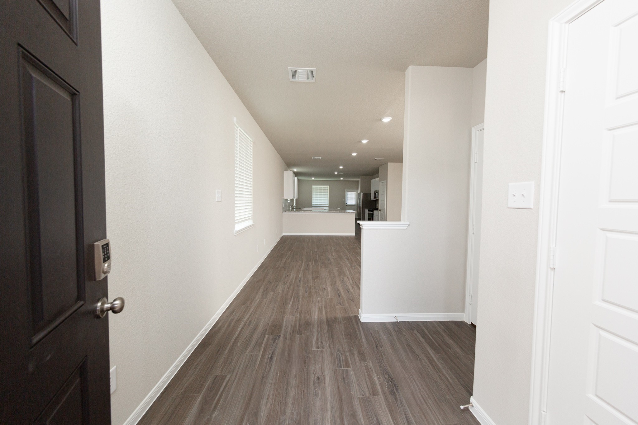 3878 Avalon Lane Conroe, TX 77301 - Photo 4 of 28 a view of a hallway with wooden floor