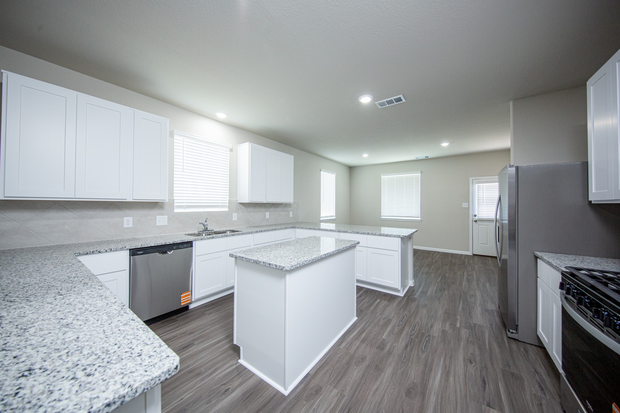 3878 Avalon Lane Conroe, TX 77301 - Photo 7 of 28 a kitchen with a sink stove top oven and cabinets