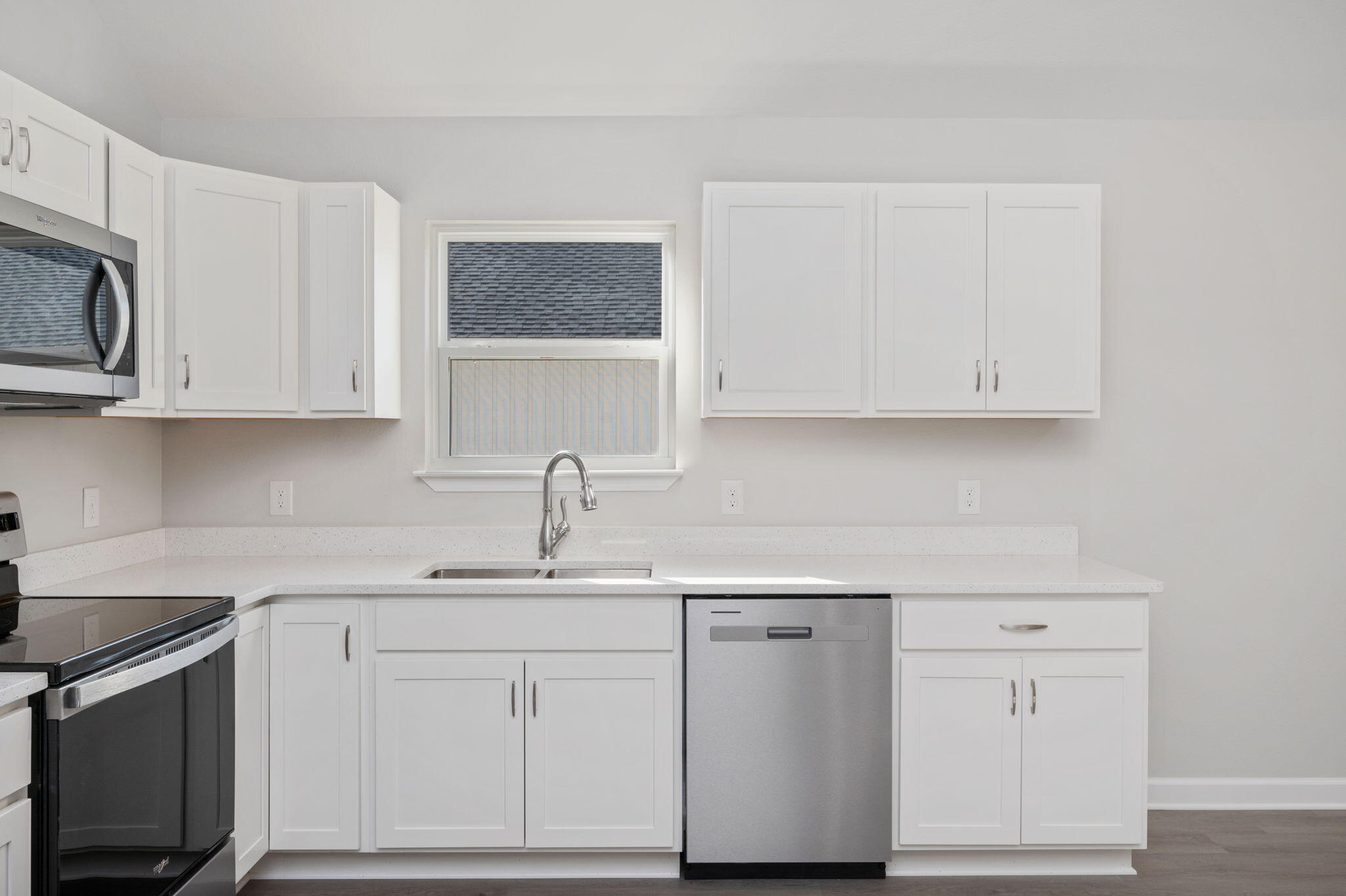 1002 Valley Road Crestview, FL 32539 - Photo 13 of 31 a kitchen with white cabinets stainless steel appliances and sink