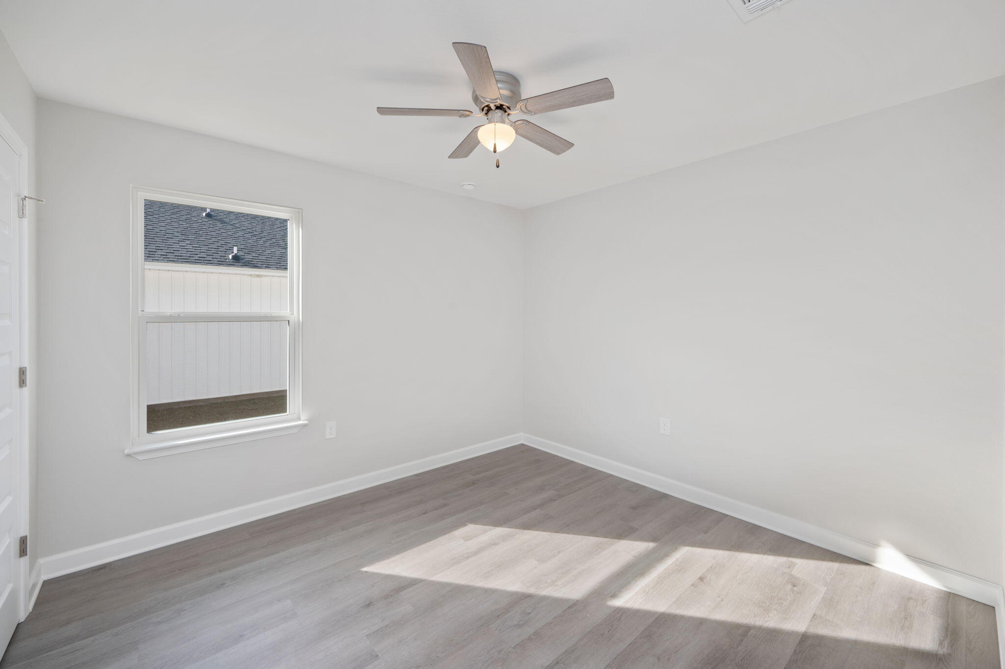 1002 Valley Road Crestview, FL 32539 - Photo 14 of 31 an empty room with a window and a ceiling fan