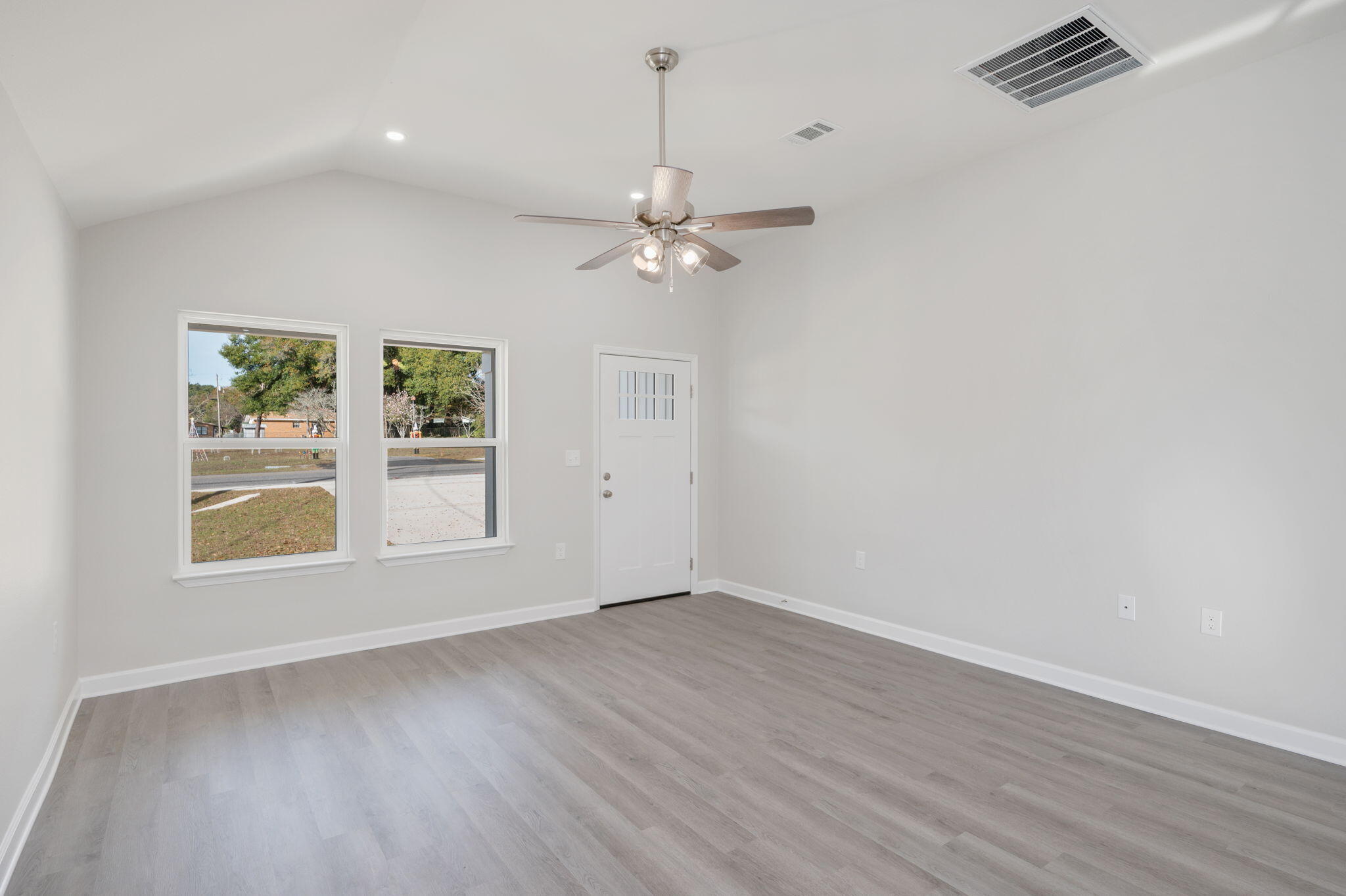 1002 Valley Road Crestview, FL 32539 - Photo 8 of 31 wooden floor in an empty room with a window