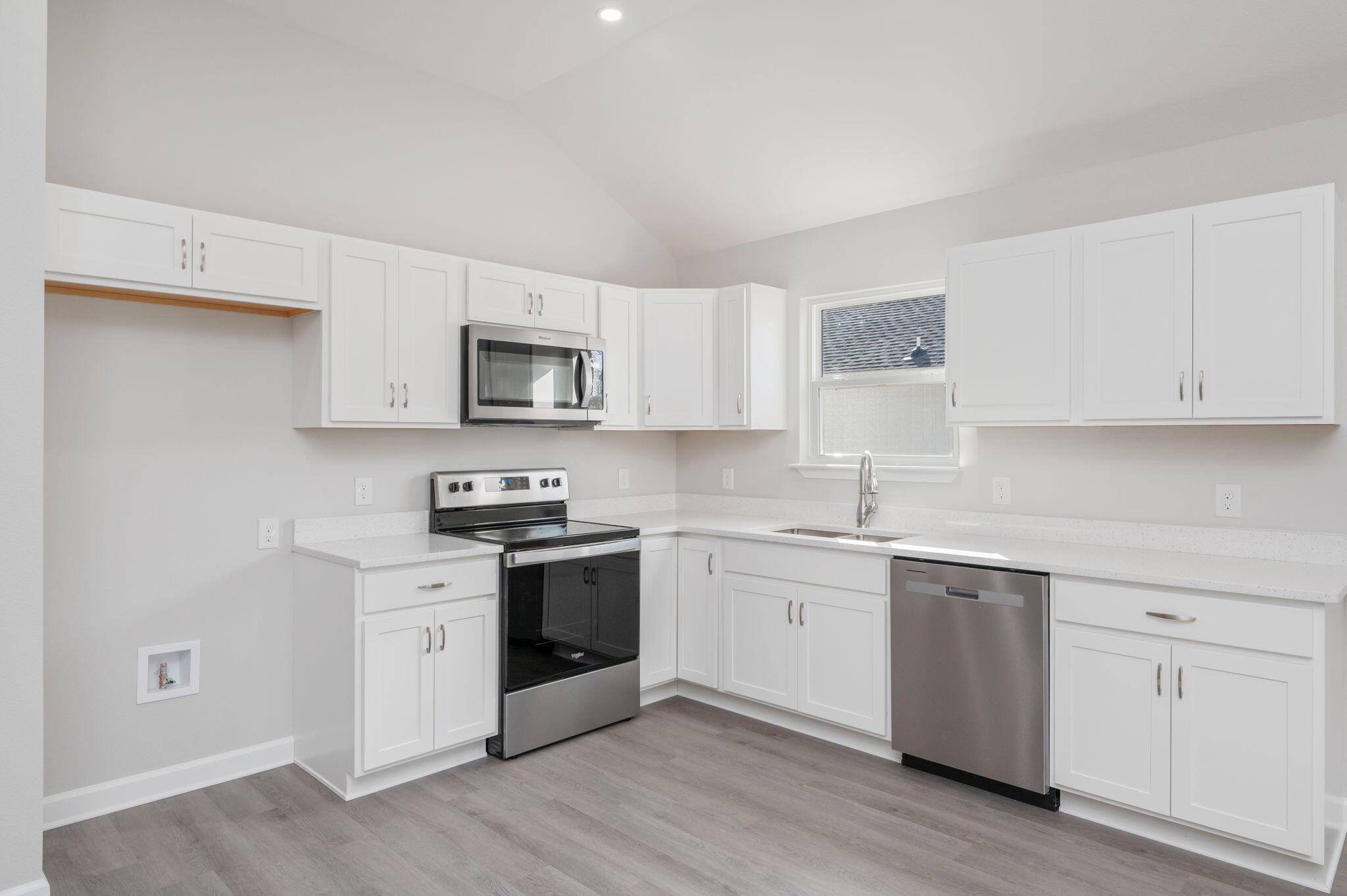 1002 Valley Road Crestview, FL 32539 - Photo 9 of 31 a kitchen with white cabinets and stainless steel appliances