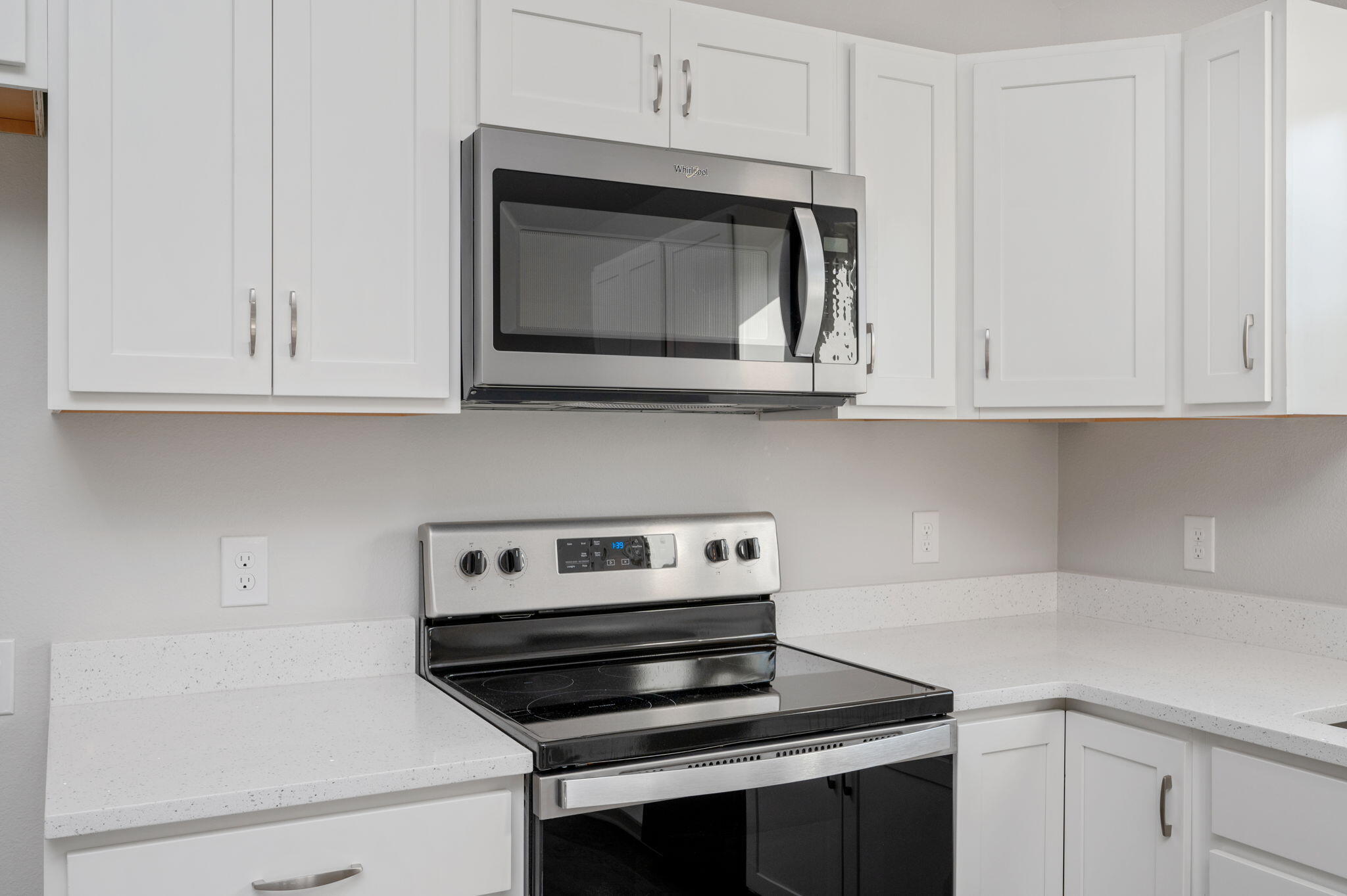 1002 Valley Road Crestview, FL 32539 - Photo 10 of 31 a kitchen with white cabinets and black appliances