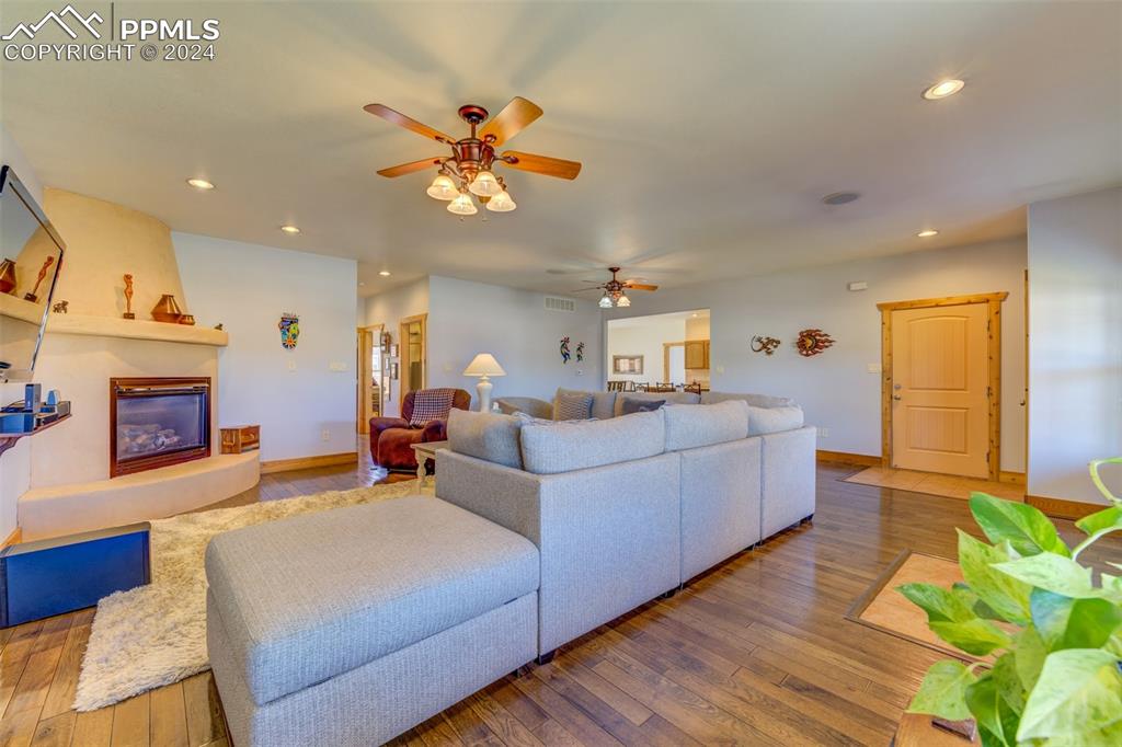 111 Rocchio Drive Florence, CO 81226 - Photo 15 of 50 a living room with furniture a fireplace and a chandelier