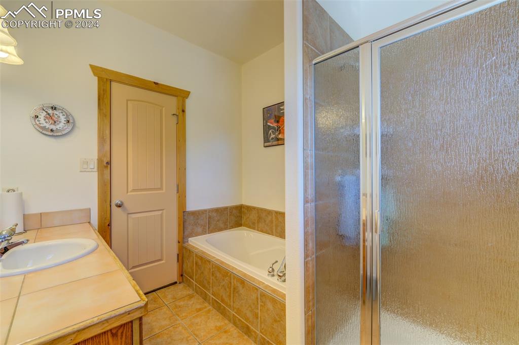 111 Rocchio Drive Florence, CO 81226 - Photo 25 of 50 a bathroom with a tub shower and sink