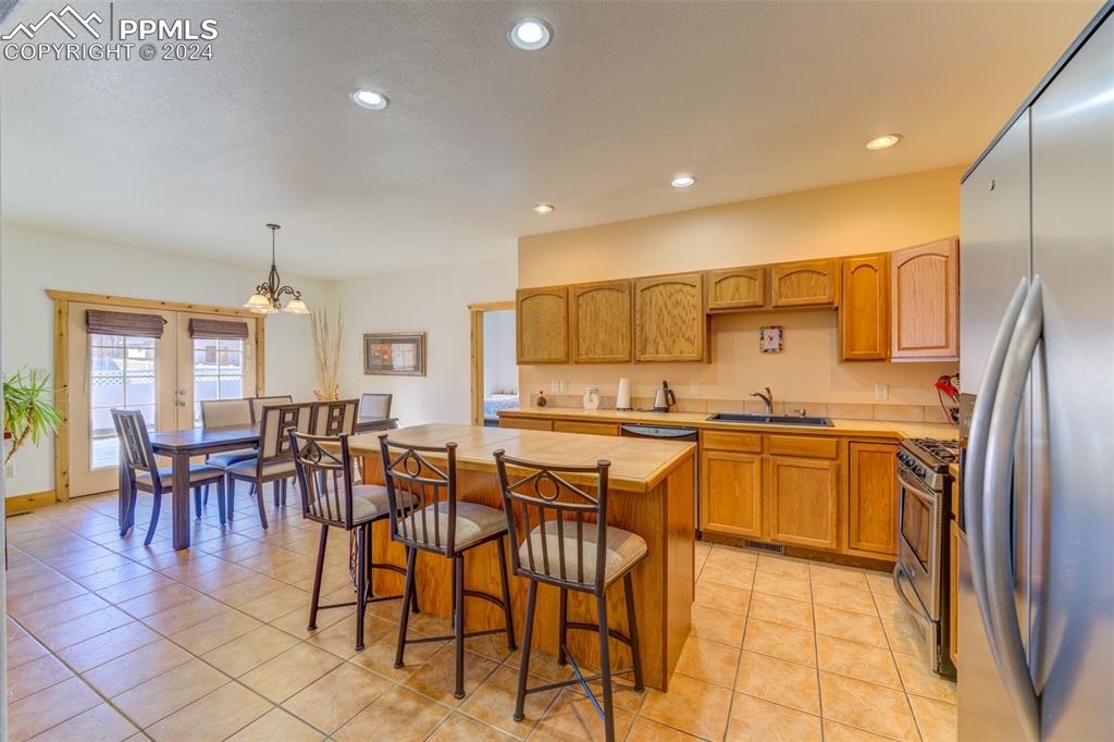 111 Rocchio Drive Florence, CO 81226 - Photo 31 of 50 a kitchen with stainless steel appliances granite countertop a table and chairs