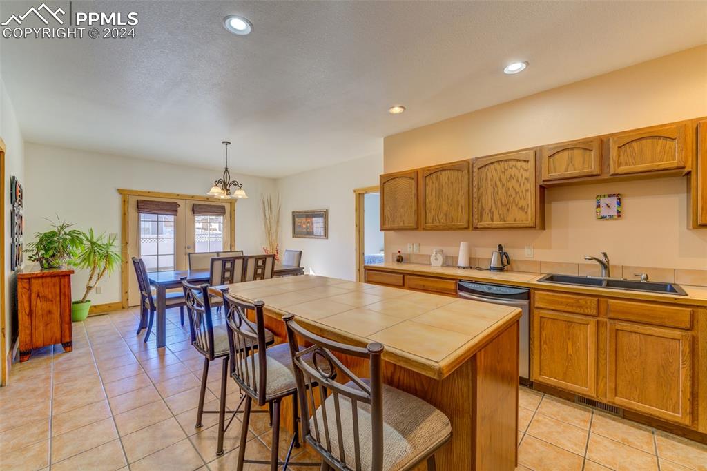 111 Rocchio Drive Florence, CO 81226 - Photo 32 of 50 a kitchen with a table chairs sink and cabinets