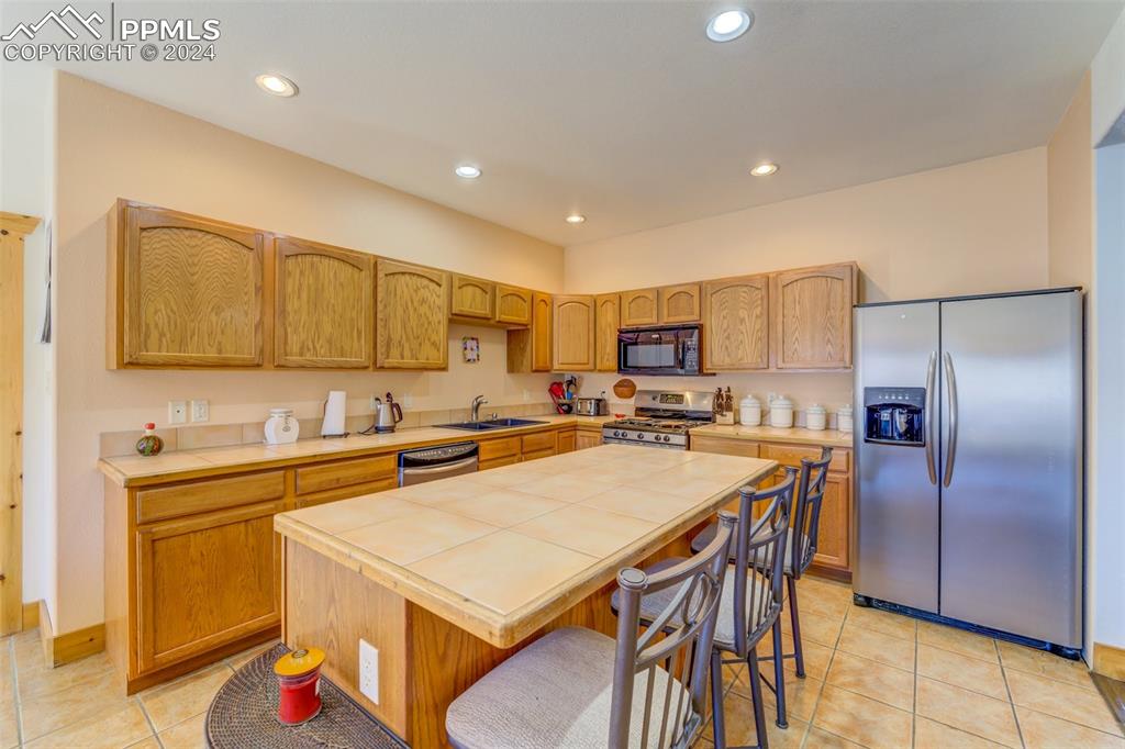 111 Rocchio Drive Florence, CO 81226 - Photo 35 of 50 a kitchen with stainless steel appliances a table and chairs