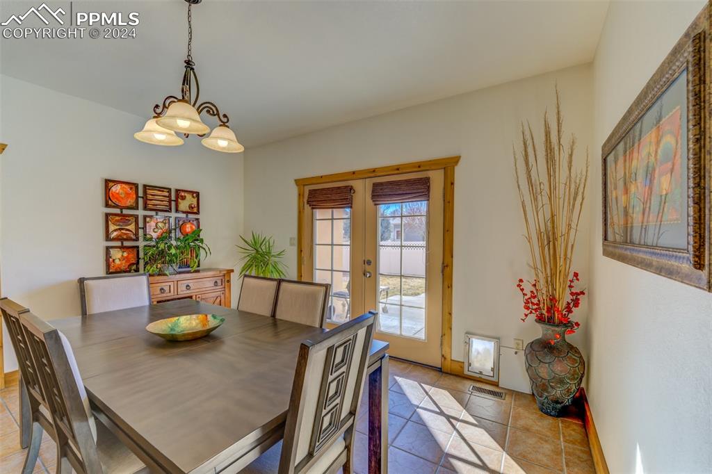 111 Rocchio Drive Florence, CO 81226 - Photo 37 of 50 a view of a dining room with furniture a chandelier and wooden floor