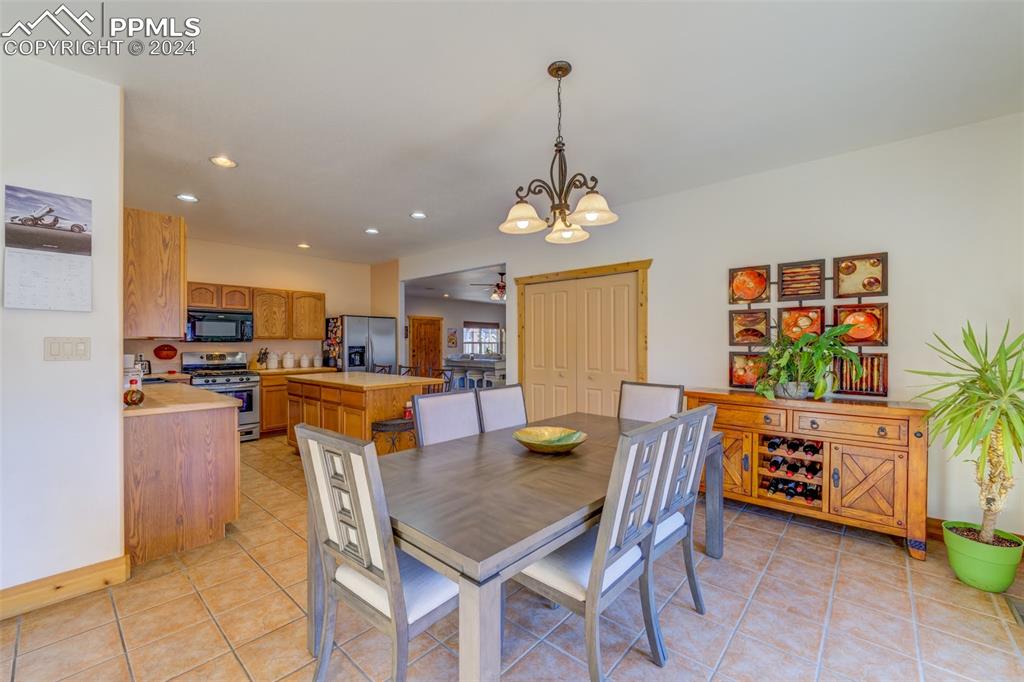 111 Rocchio Drive Florence, CO 81226 - Photo 39 of 50 a view of a dining room with furniture and a chandelier