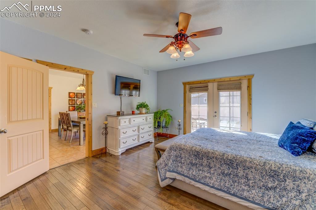 111 Rocchio Drive Florence, CO 81226 - Photo 43 of 50 a bedroom with a bed a dresser and wooden floor