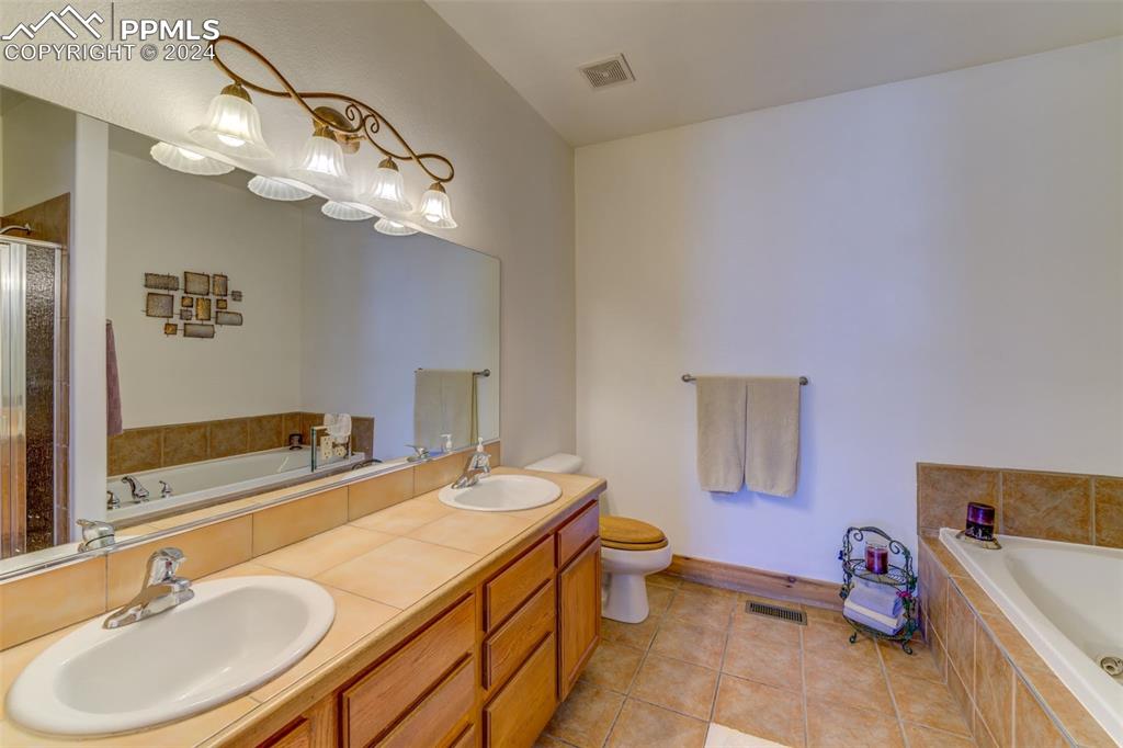 111 Rocchio Drive Florence, CO 81226 - Photo 45 of 50 a bathroom with a sink a toilet and a mirror