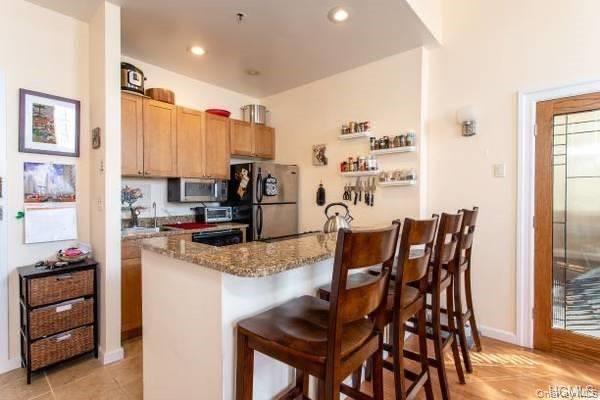 a kitchen with stainless steel appliances kitchen island granite countertop a table and chairs