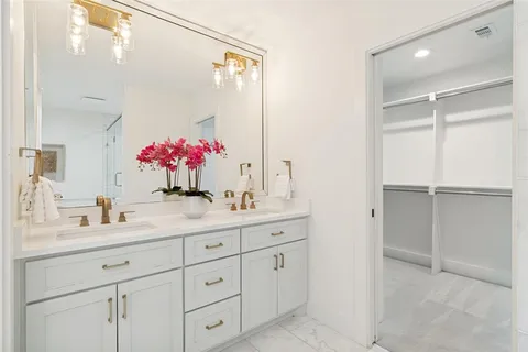 a bathroom with a sink vanity tub and shower