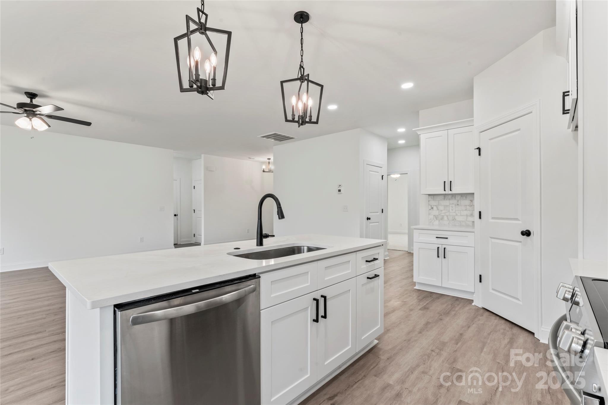 1 Morehead Road Harrisburg, NC 28075 - Photo 11 of 32 a kitchen with stainless steel appliances granite countertop a sink a stove a dining table and chairs