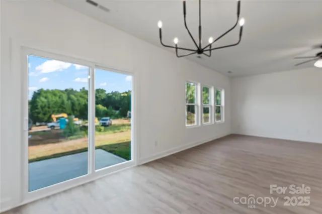 a kitchen with white cabinets and stove